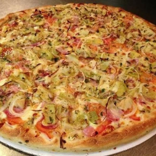 Large pizza with artichoke hearts, red onions, tomatoes, and melted cheese on a golden crust.