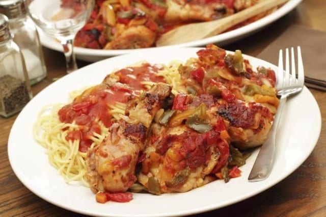 CHICKEN CACCIATORE OVER SPAGHETTI.