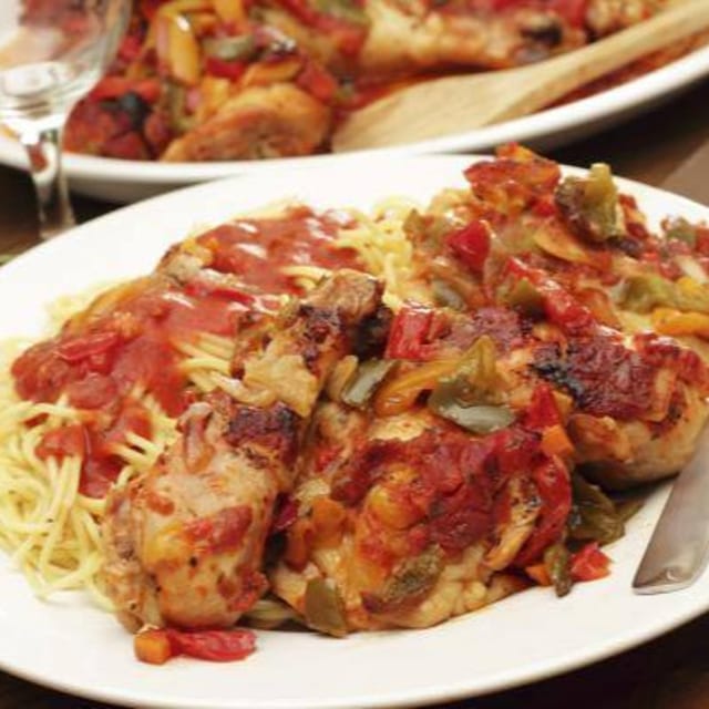 CHICKEN CACCIATORE OVER SPAGHETTI.